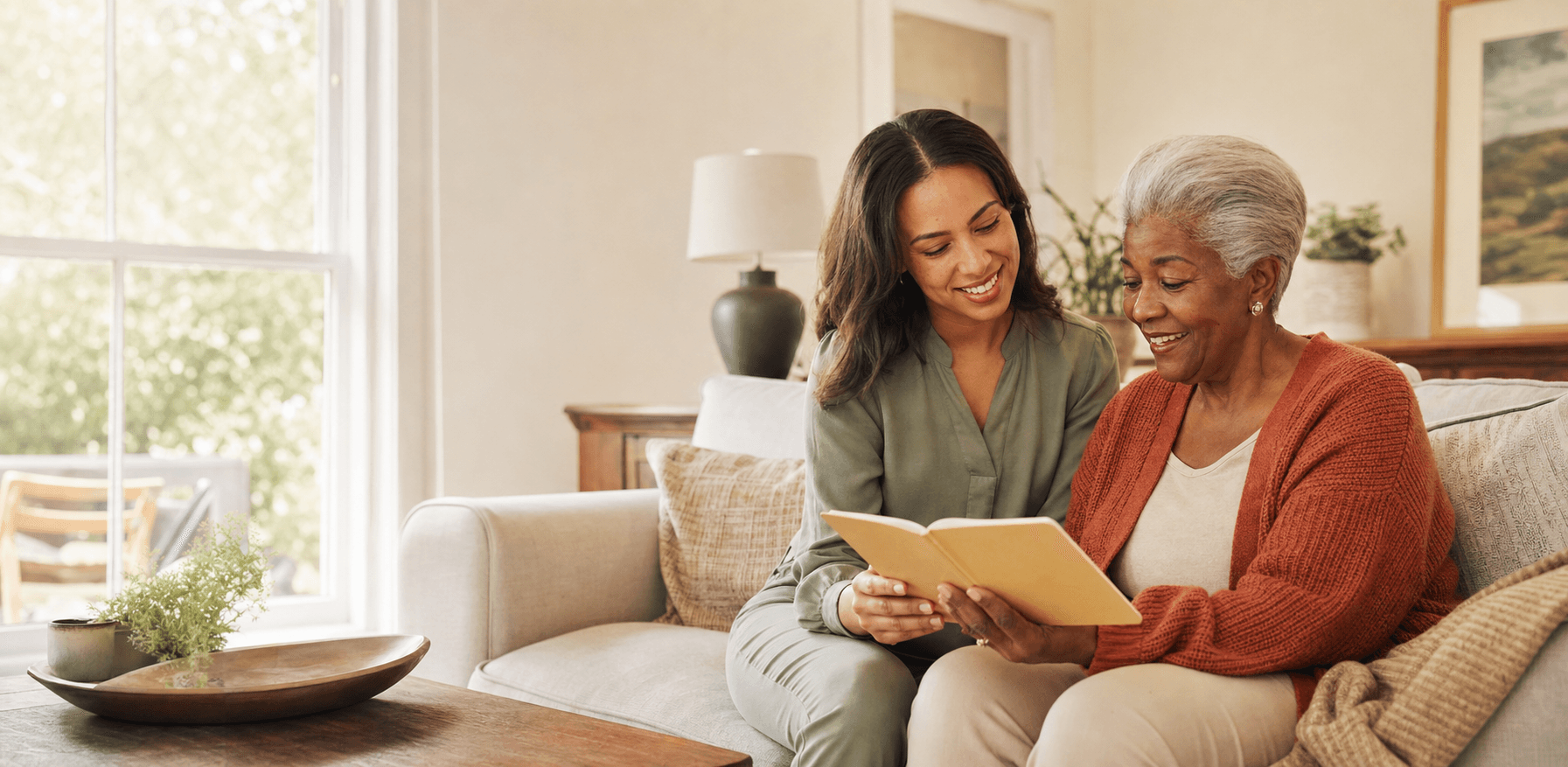 Warmheart caregiver sitting with an older adult in a comfortable home